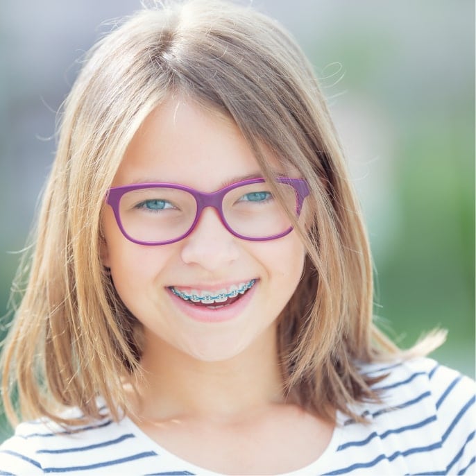 Young girl with braces smiling