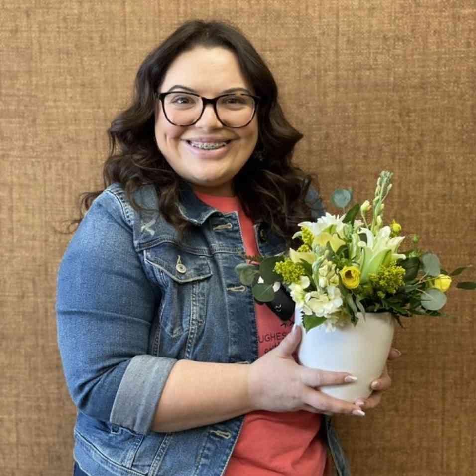 Patient holding flowers and smiling