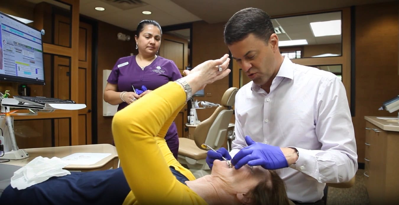 Orthodontist examining patient's teeth